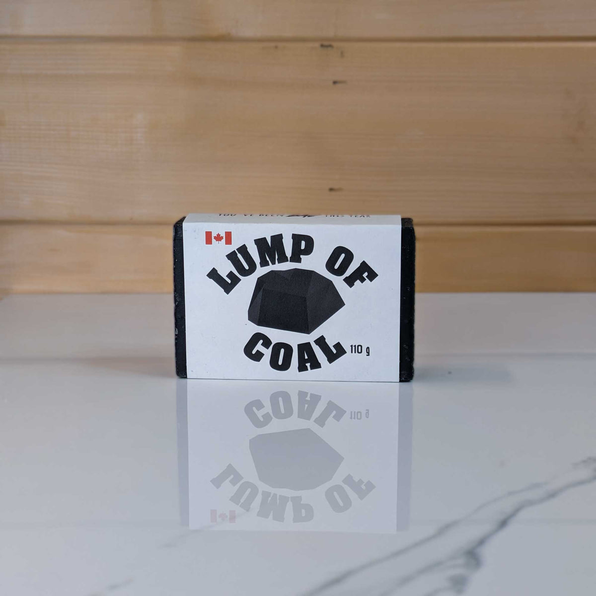 Lump of Coal charcoal soap by PoCo Soap Co. in black and white packaging. The perfect holiday stocking stuffer made with activated charcoal and skin-nourishing shea butter.