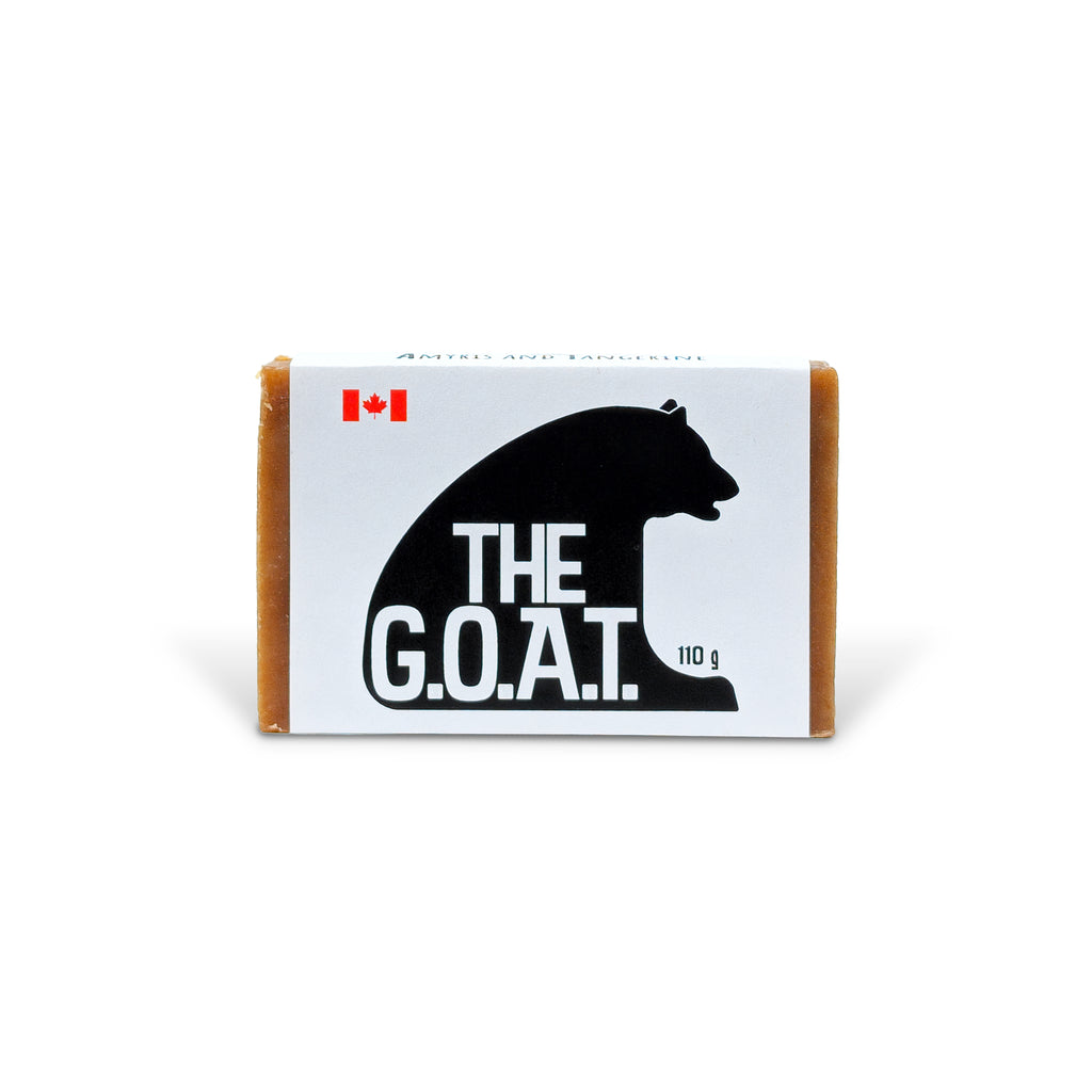 The G.O.A.T. natural soap bar by PoCo Soap Co. in black and white packaging. Handcrafted with goat's milk, colloidal oatmeal, and essential oils of Amyris and Tangerine for sensitive skin.